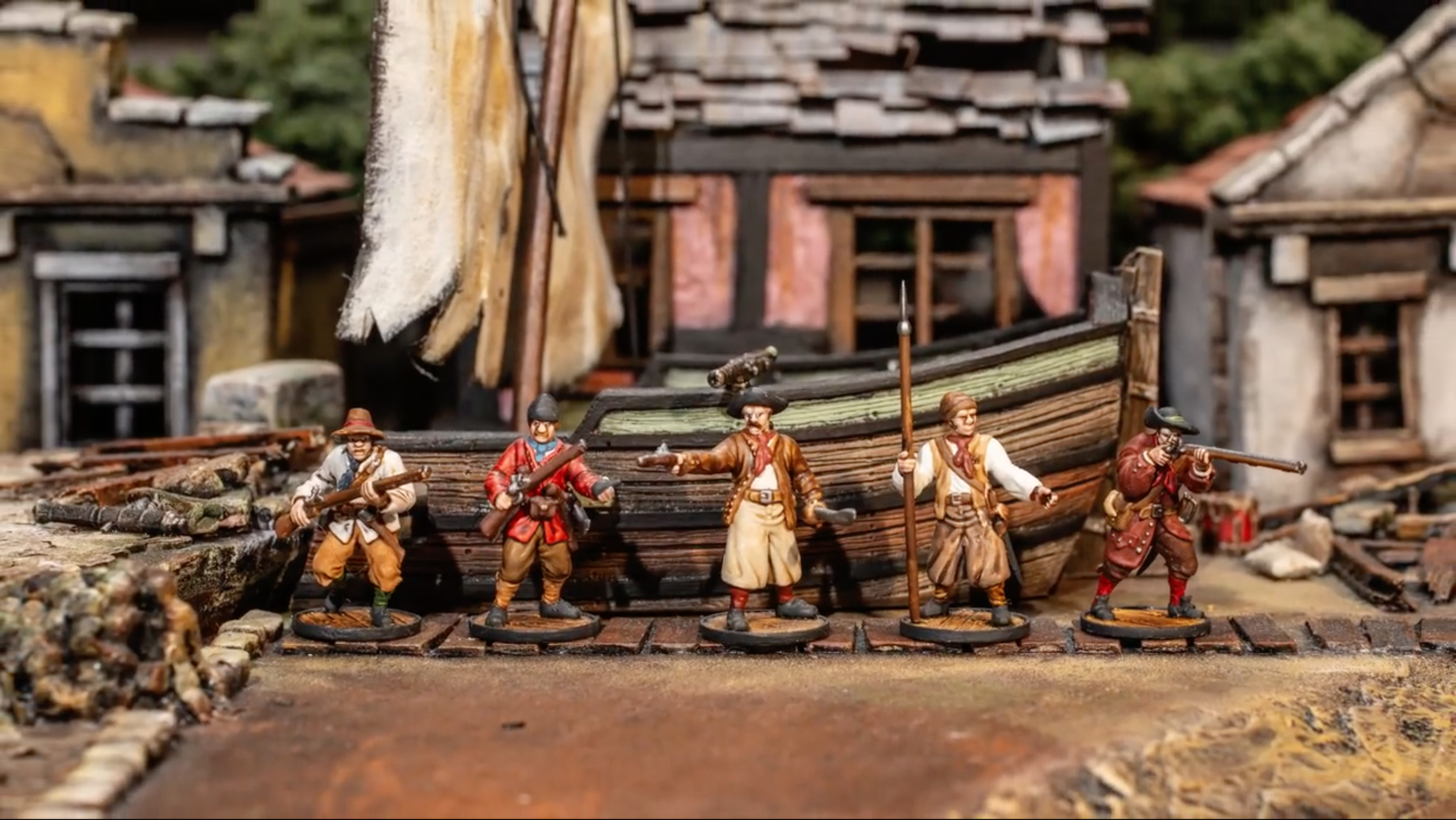 French Buccaneers Faction of miniatures in front of a ship that has run aground and some ruined houses